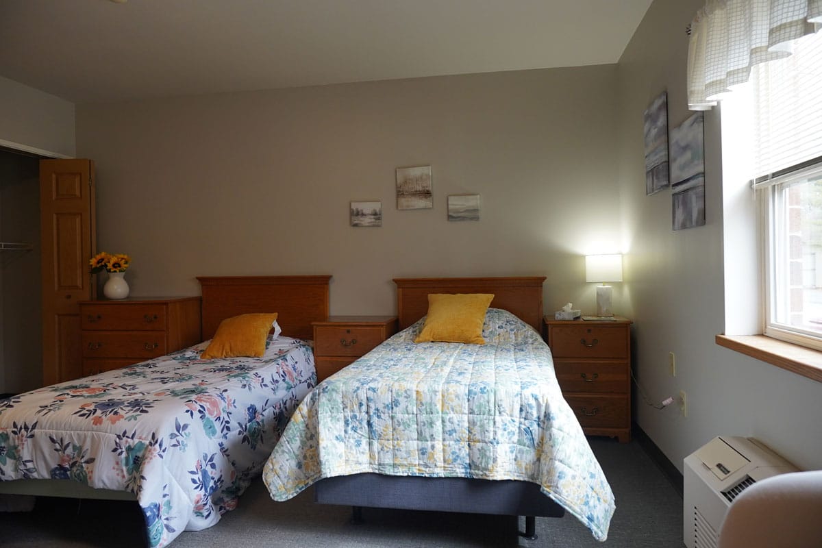 A cozy shared bedroom with two beds and decor