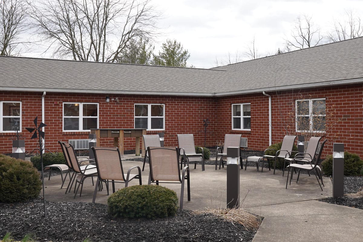 Seating area on the outdoor patio with chairs and light fixtures.