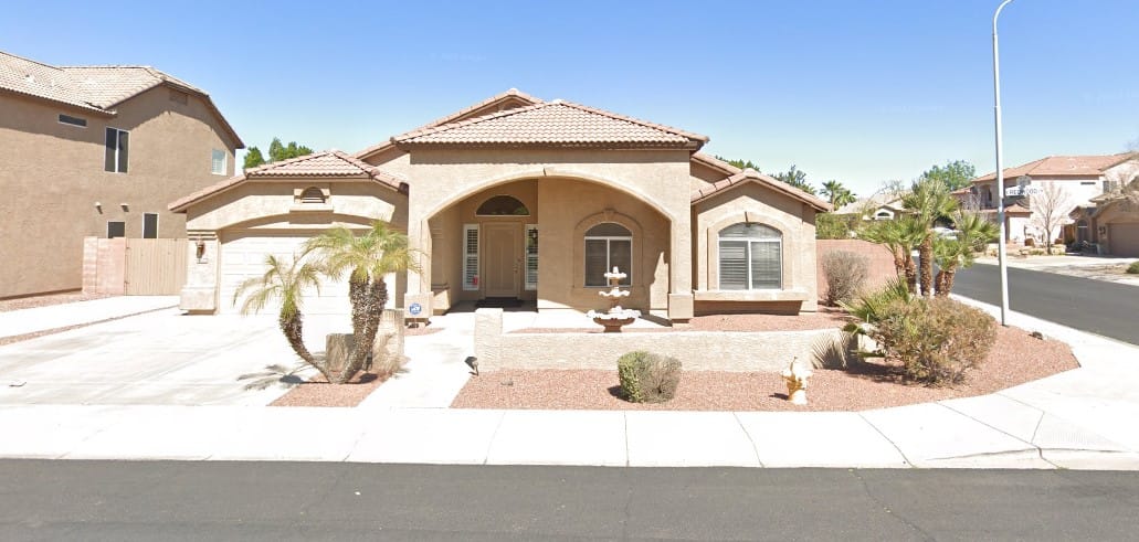Exterior of a residential building with a driveway and landscaping