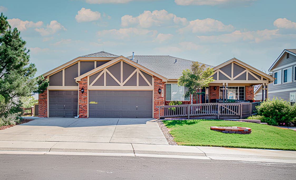Exterior view of a residential building with landscaped yard