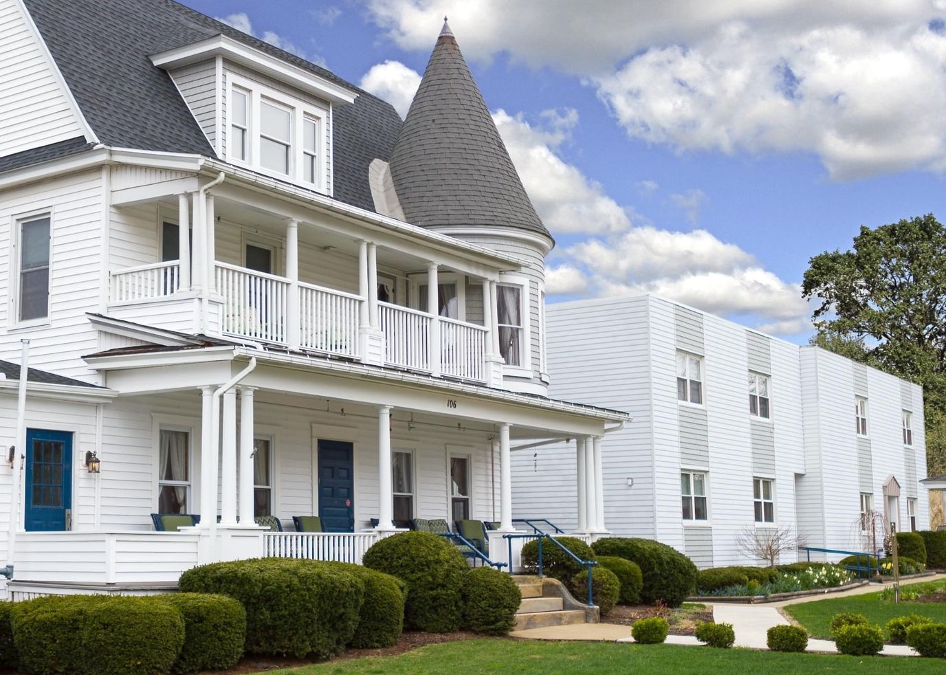 Exterior view of a senior living facility with manicured gardens