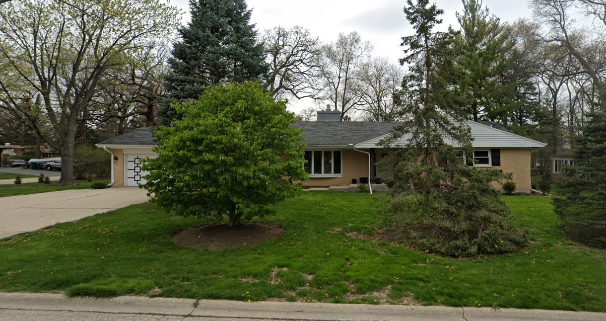 Exterior view of a residential care facility surrounded by greenery