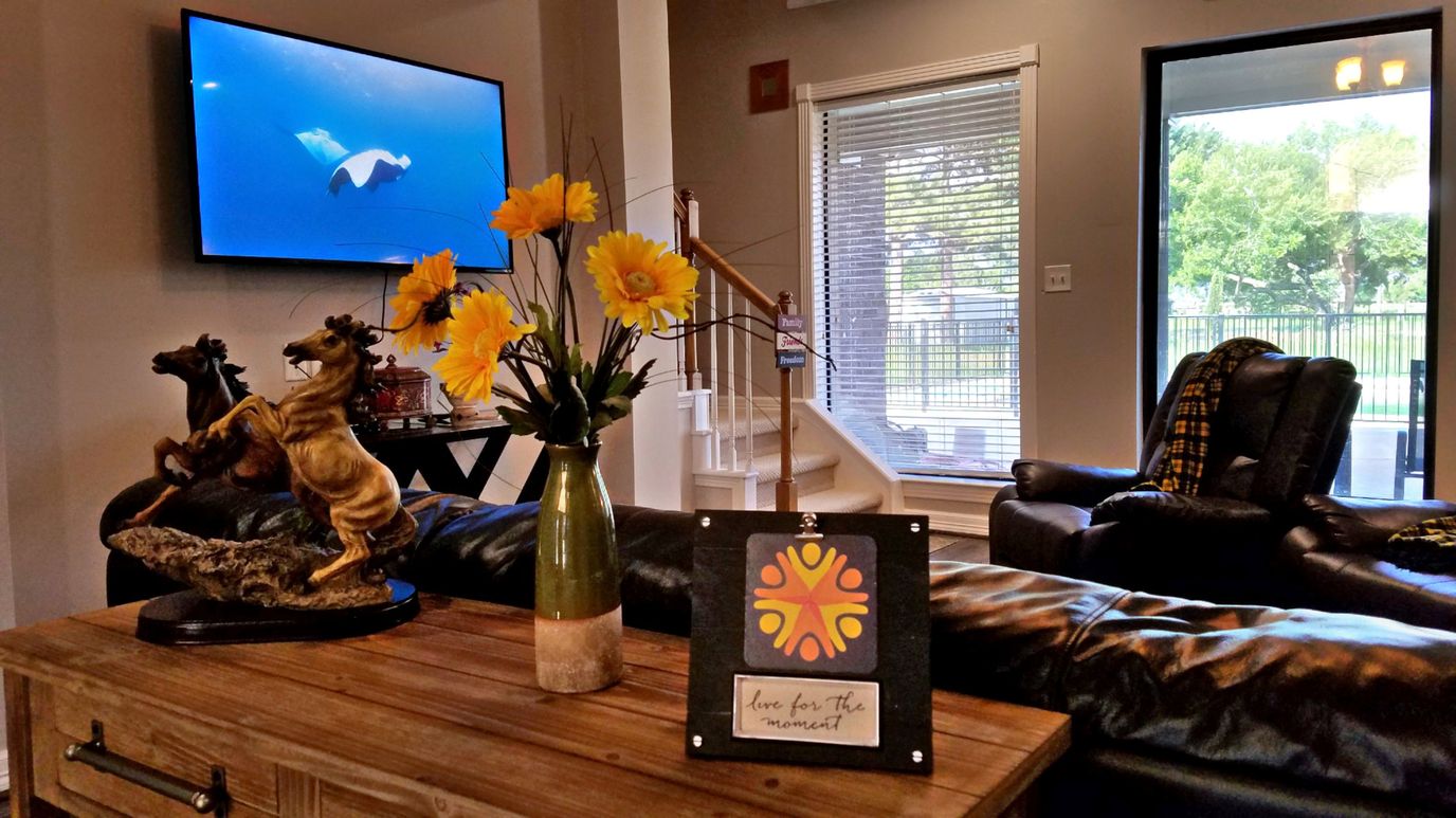 Vivid Life Residential Care, assisted living in Richmond, TX — Decorative living room with flowers and artwork