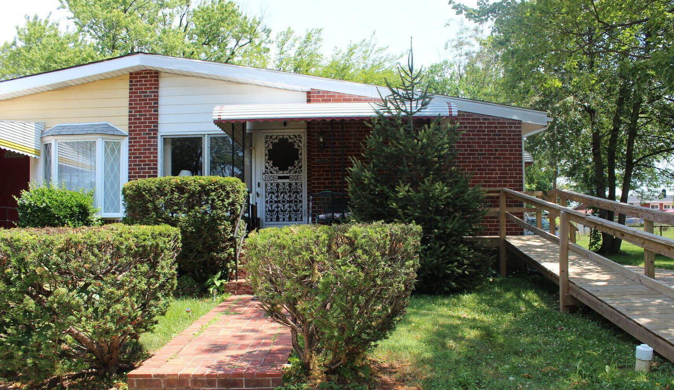 Exterior view of a senior living facility with landscaping