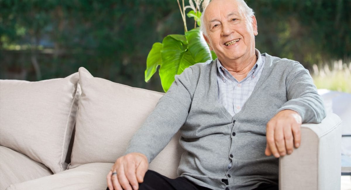 Smiling senior man sitting on a couch