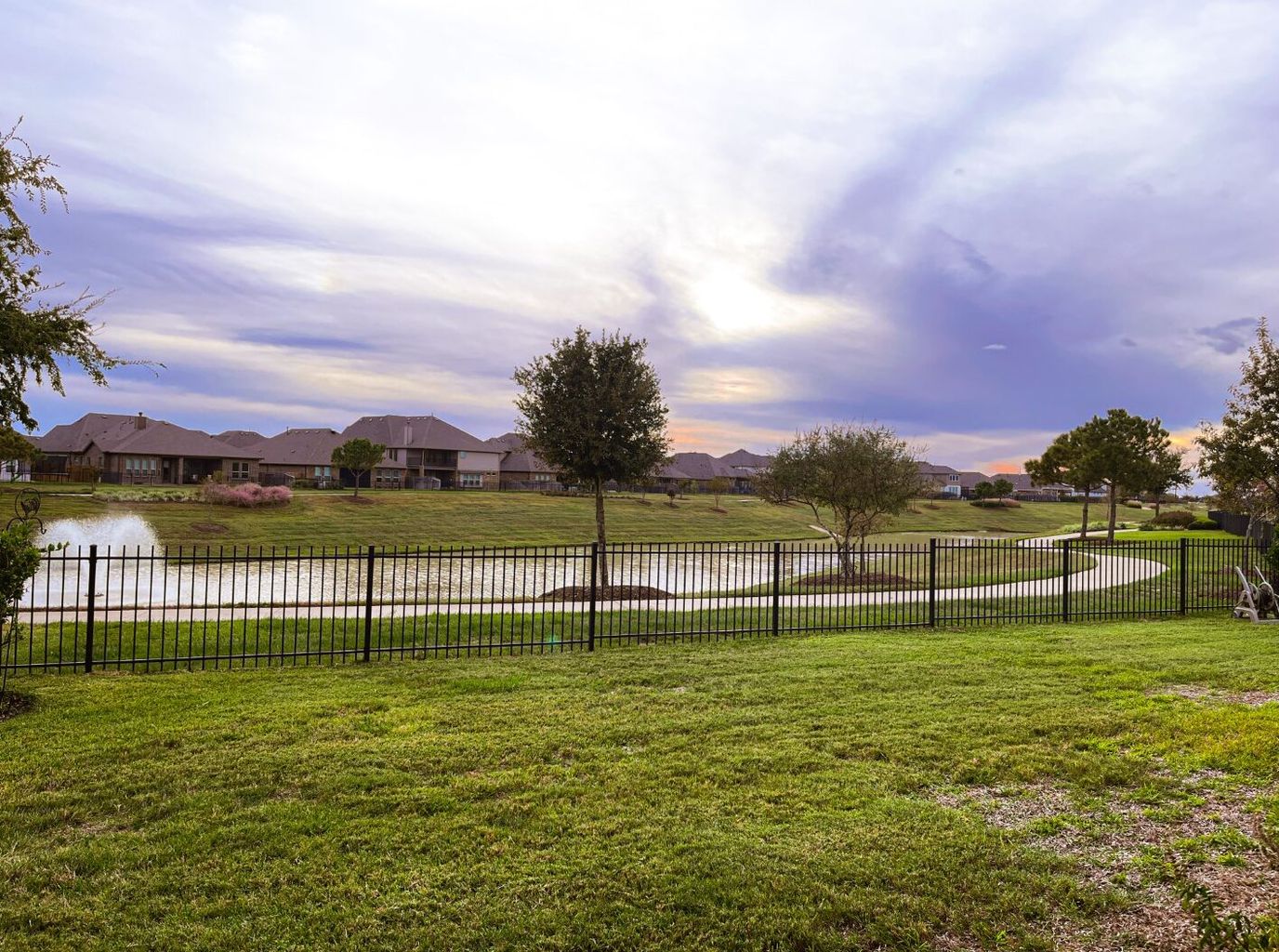 Scenic view of a lake and lawn at sunset