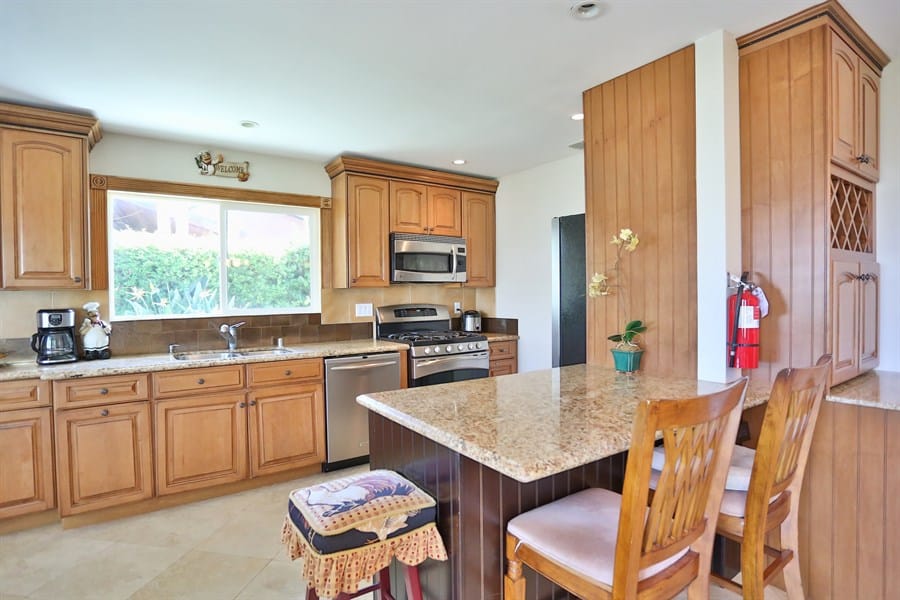 Bright kitchen area with wooden cabinets