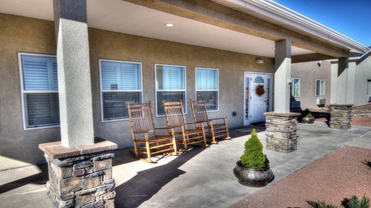 Exterior view of the facility with rocking chairs