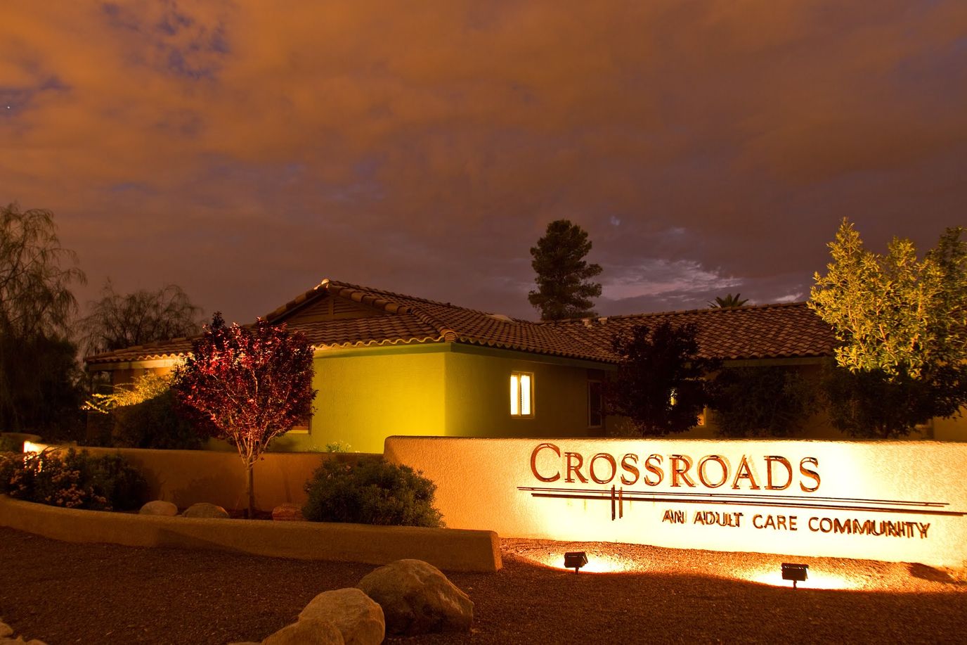Exterior view of Crossroads Assisted Living at night