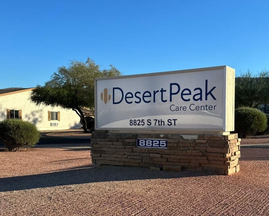 Sign for Desert Peak Care Center at the entrance