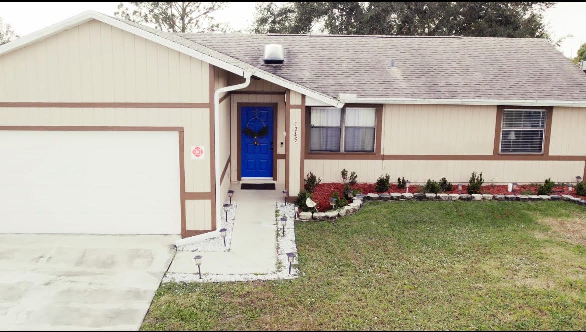 Exterior view of a single-family home with a blue door