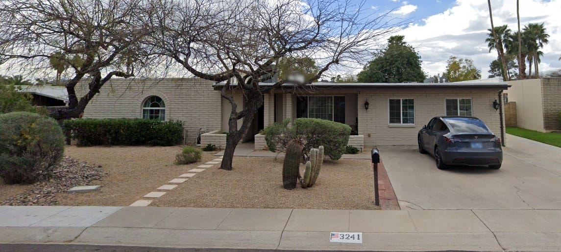 Exterior view of a residential building with landscaped front yard