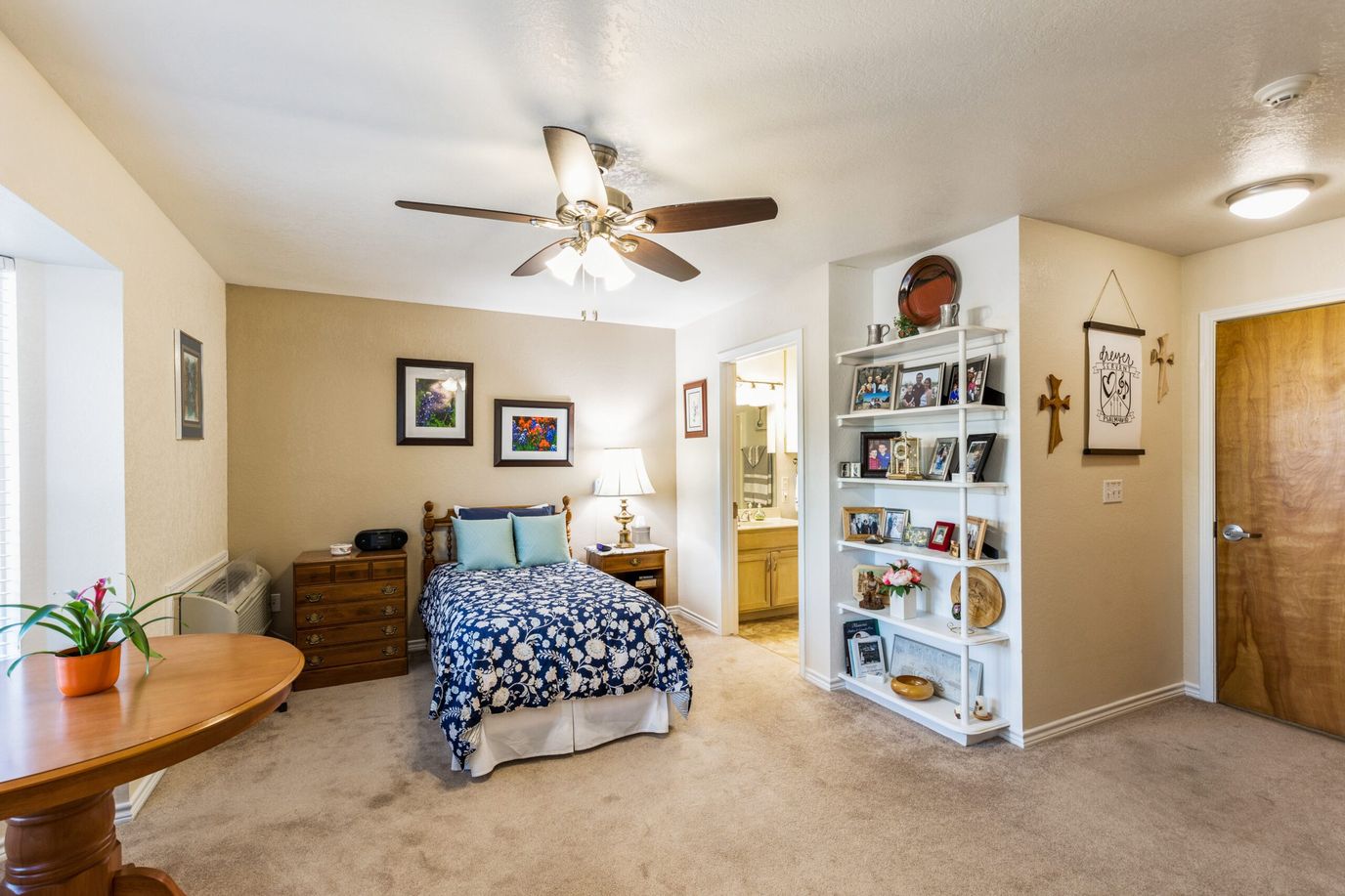 Comfortable bedroom with a floral bedspread and personal decor