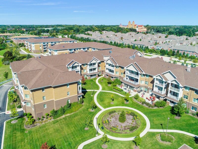 Aerial view of a senior living facility with landscaped gardens