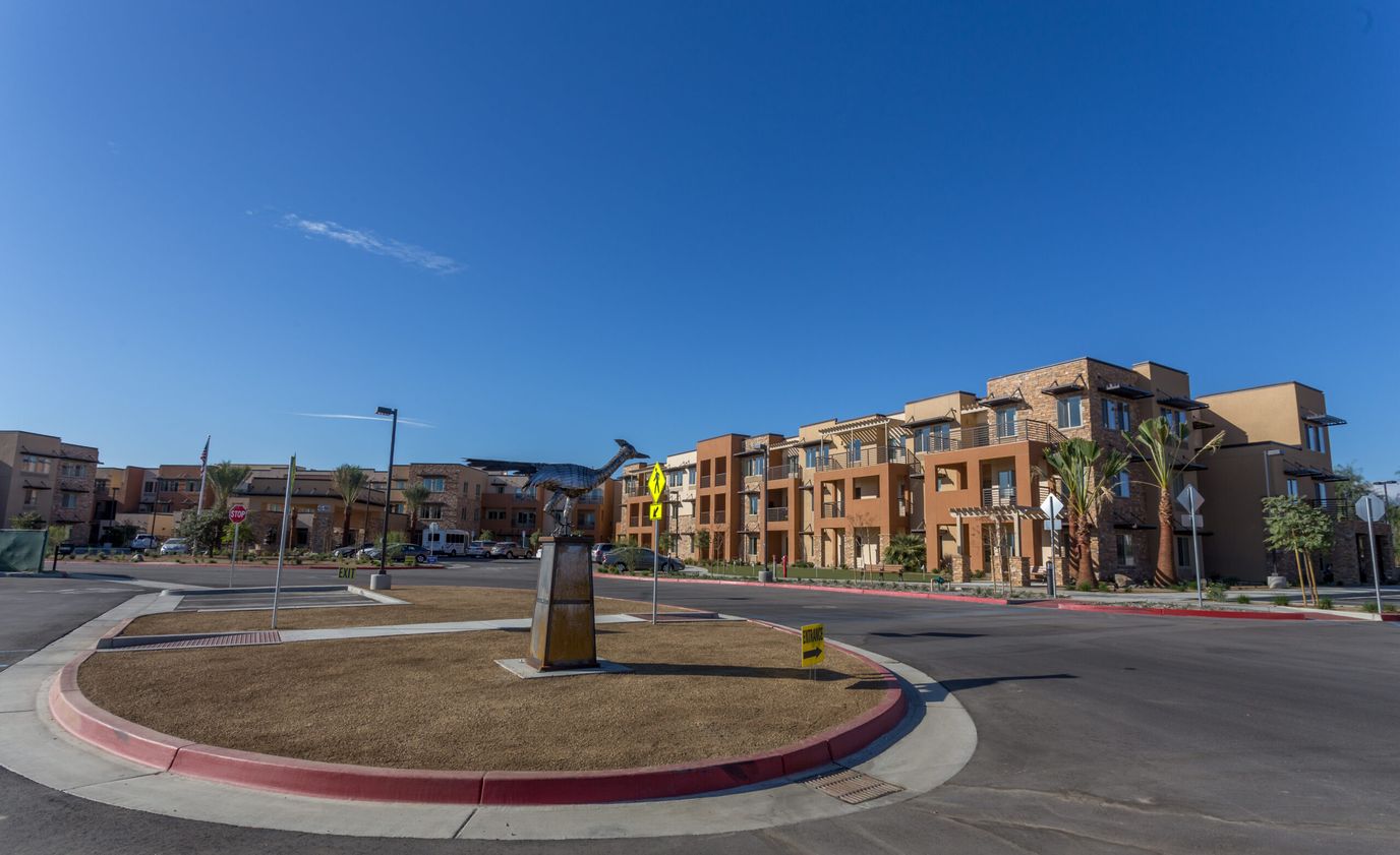 Exterior view of a senior living facility with landscaped entry.