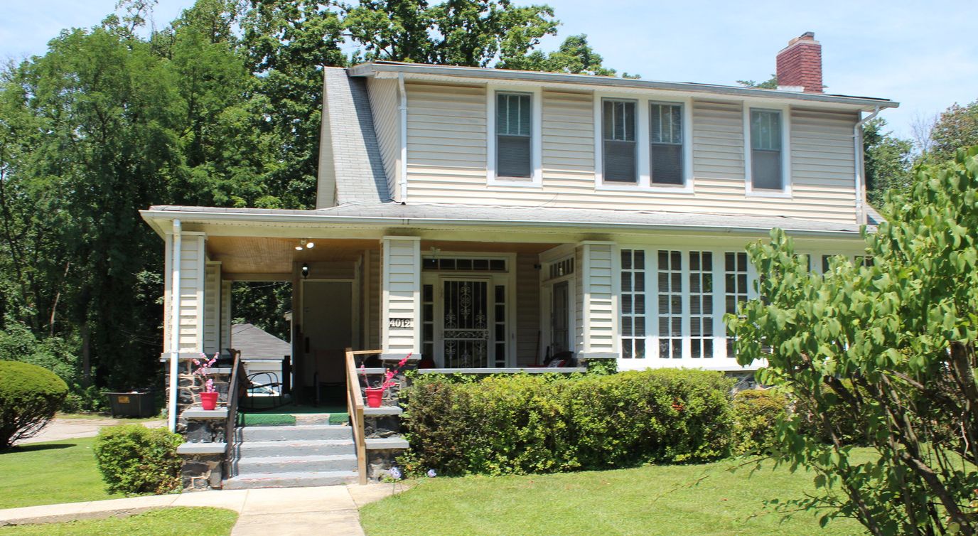 Exterior view of a senior living facility with greenery