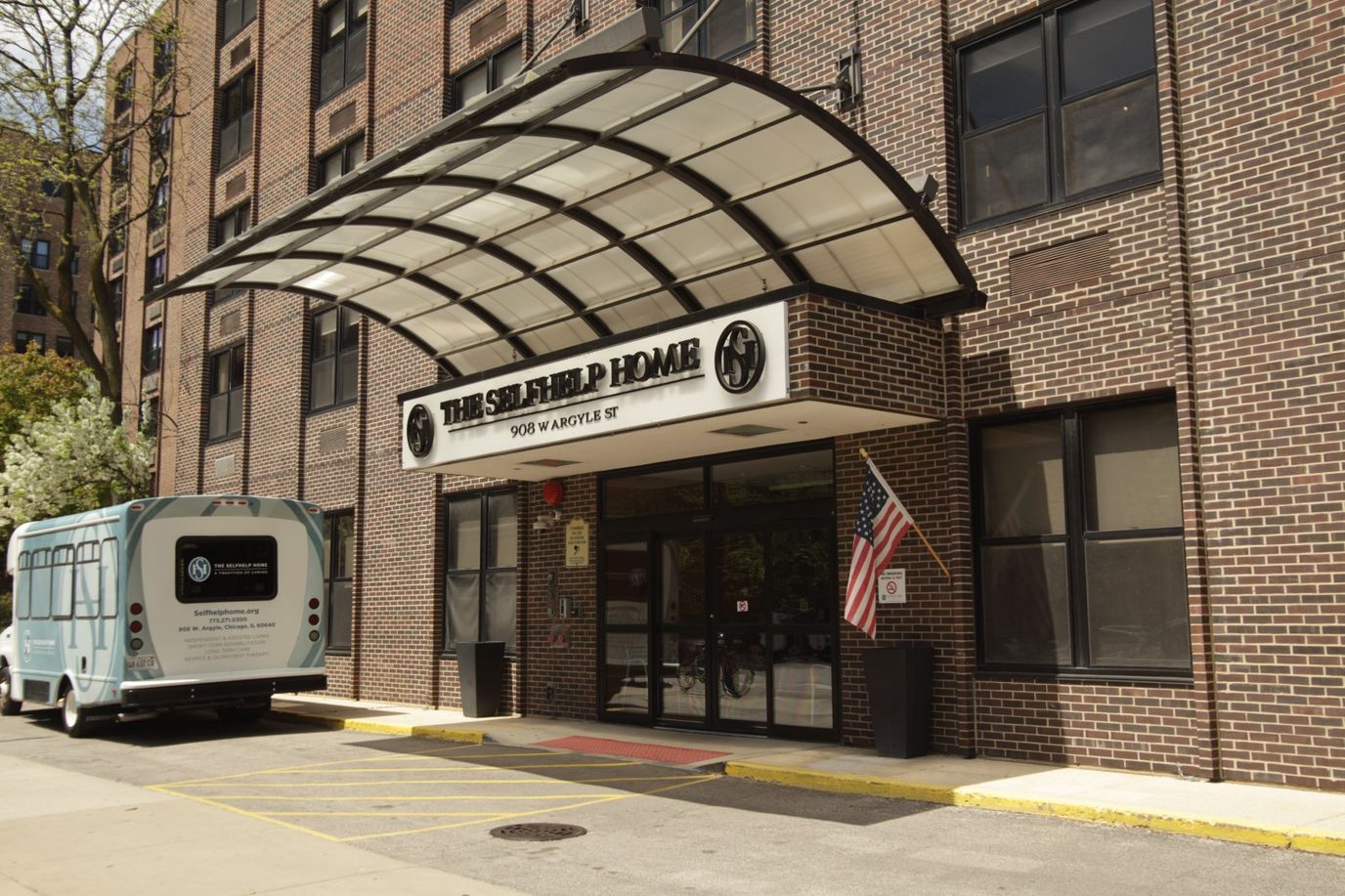 Front entrance of The Selfhelp Home with a shuttle bus