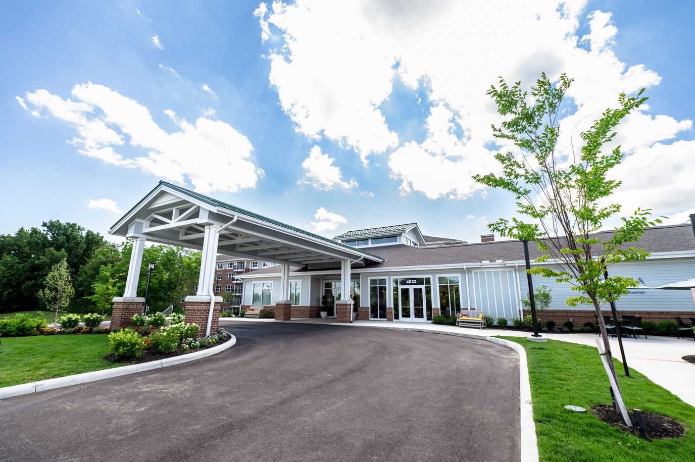 Facility exterior with a covered entrance and landscaping
