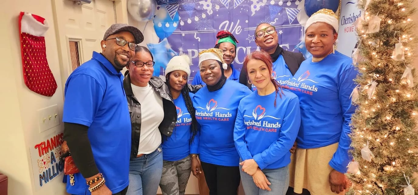 Group of staff members in blue shirts at an indoor event