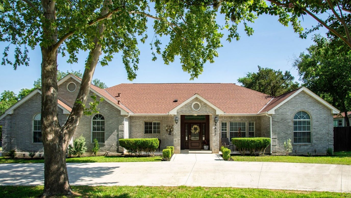 Exterior view of a nursing home facility surrounded by trees