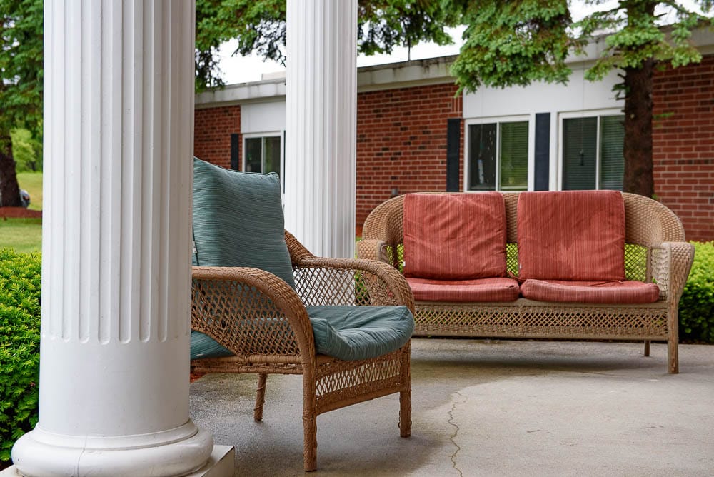 Outdoor seating area with wicker furniture and columns