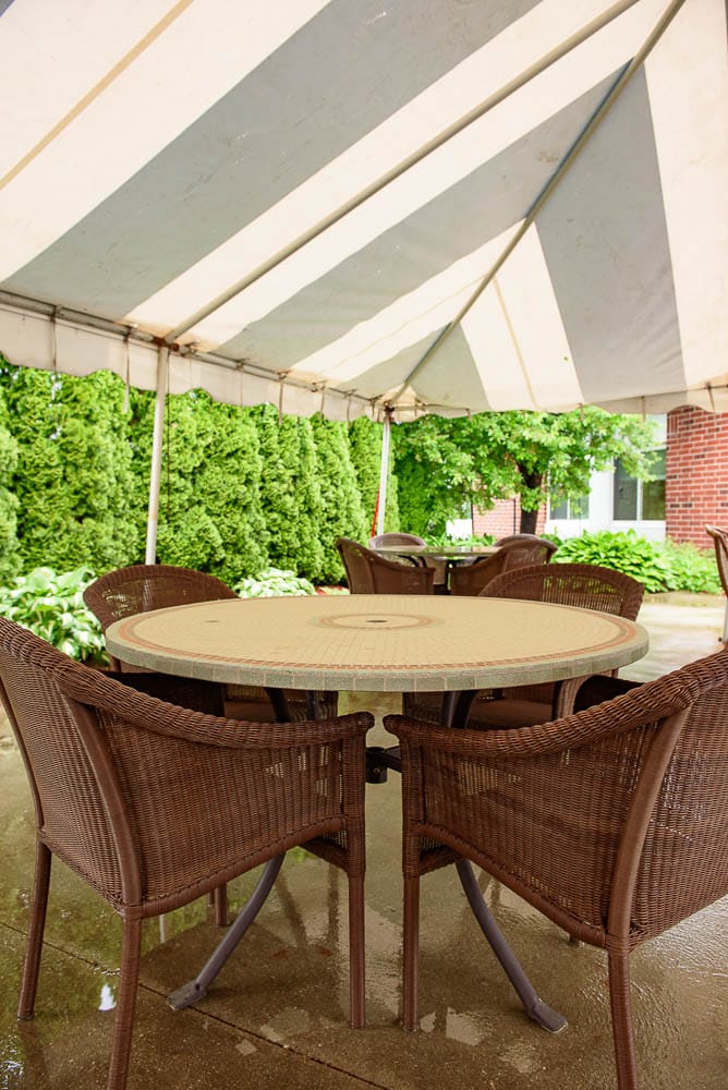 Outdoor seating area under a striped tent