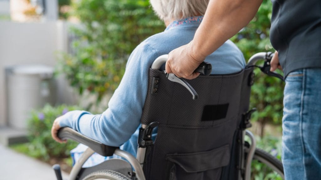 Caregiver assisting a resident in a wheelchair