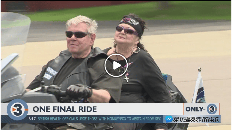 Couple riding a motorcycle together outdoors