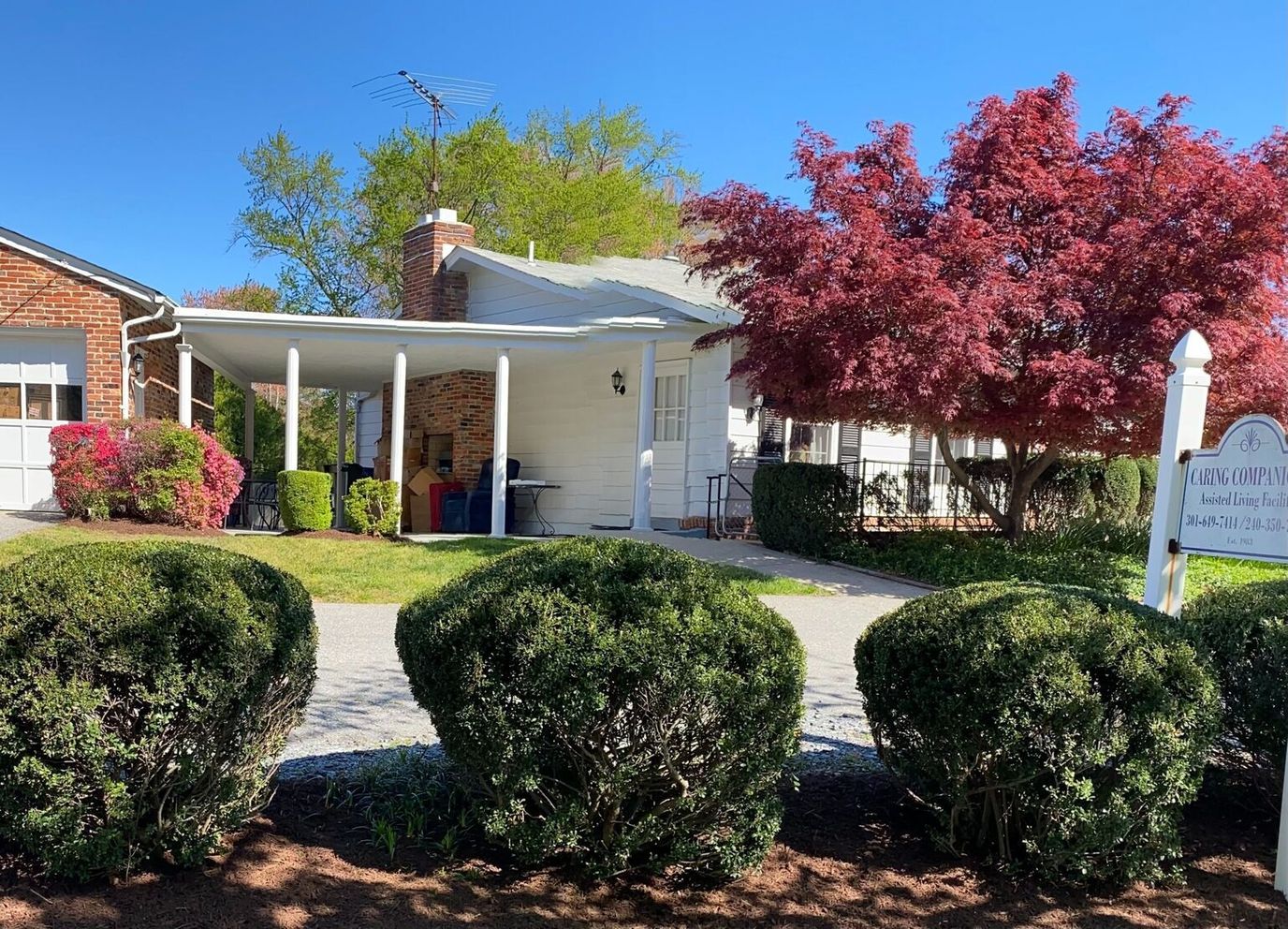 Exterior view of Caring Companions Inc with colorful landscaping