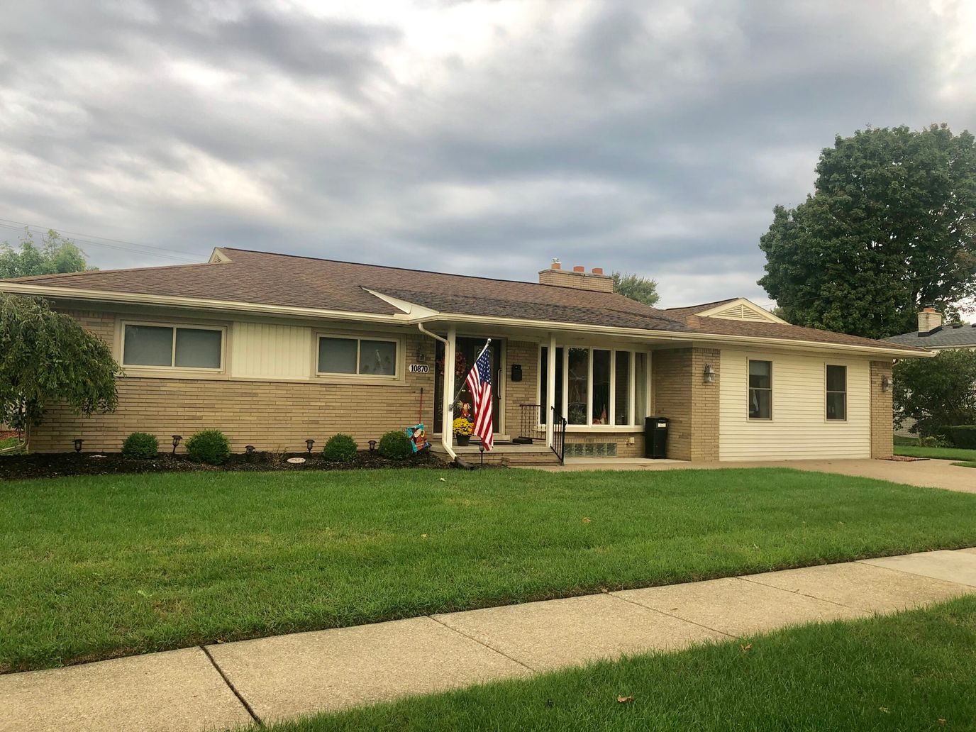 Exterior view of a senior living facility with a flag