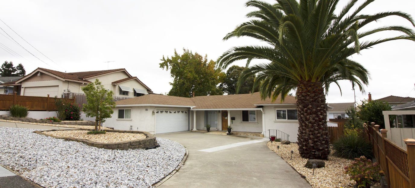 Exterior view of Blessing Home Assisted Living with palm trees