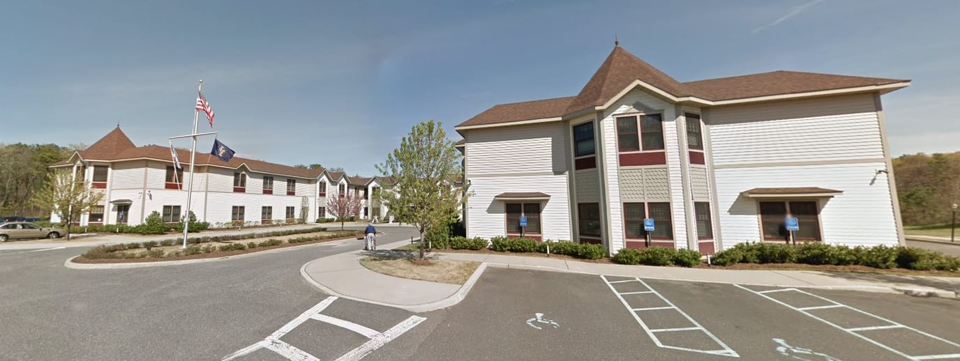 Exterior view of Braemar at Medford with residents outside