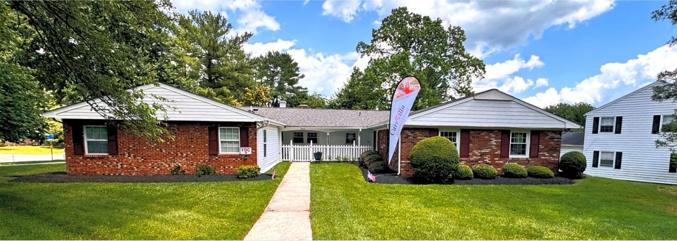 Exterior view of CareVilla Blue Spruce with garden and entrance