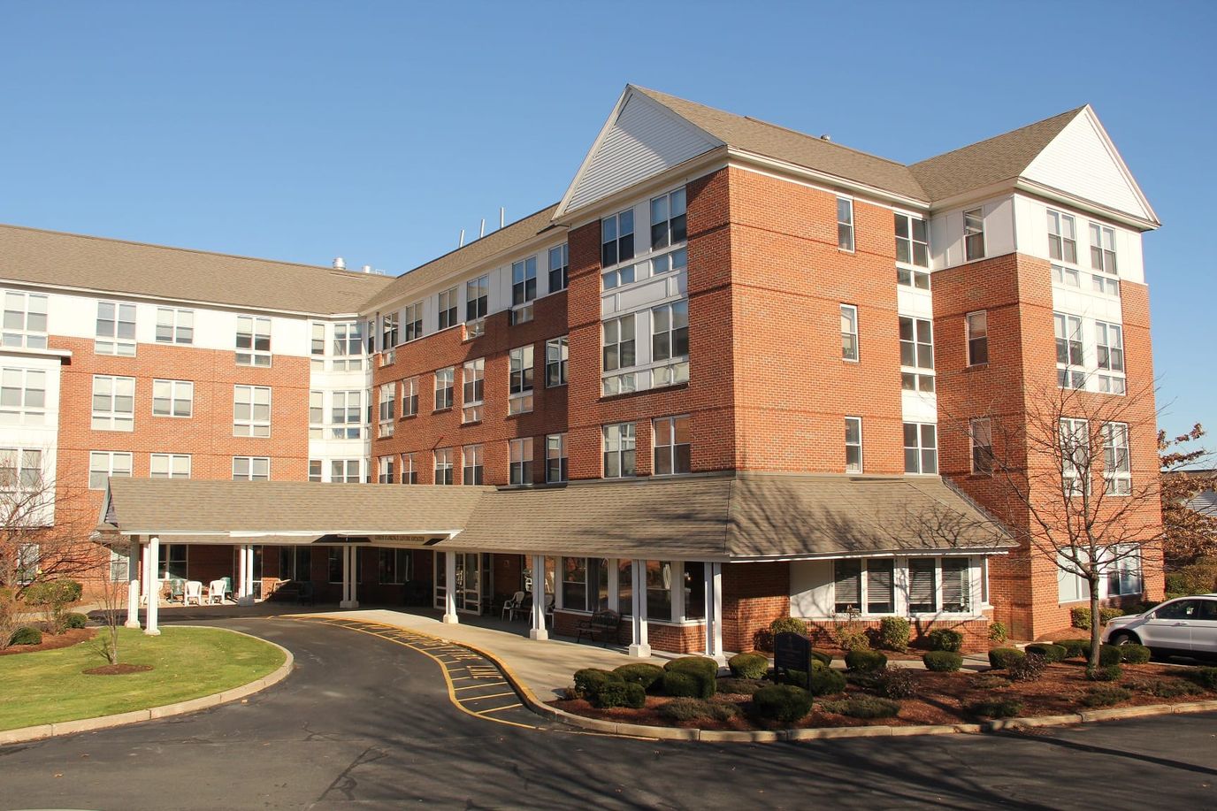 Exterior view of a senior living facility with landscaping