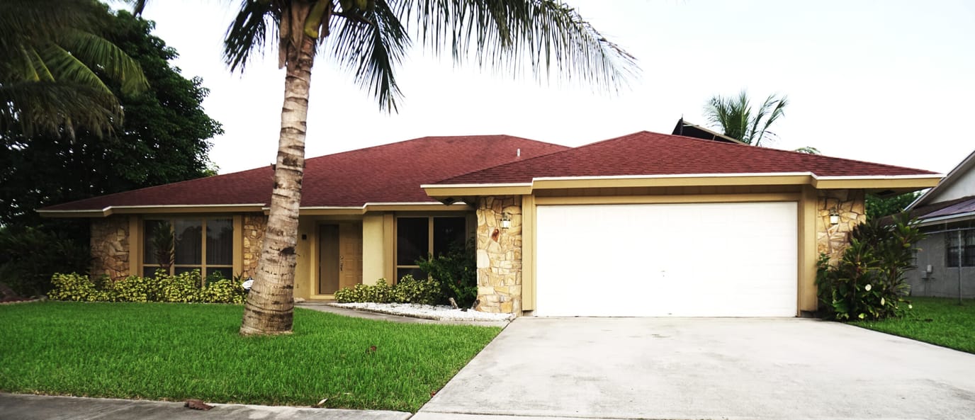 Exterior view of a residence with palm trees