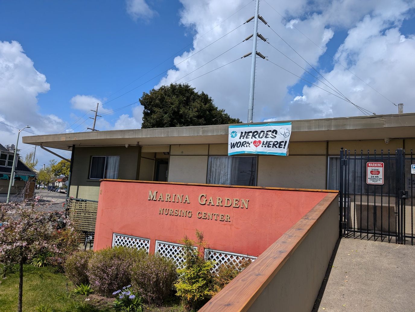 Exterior view of Marina Garden Nursing Center with a welcoming sign