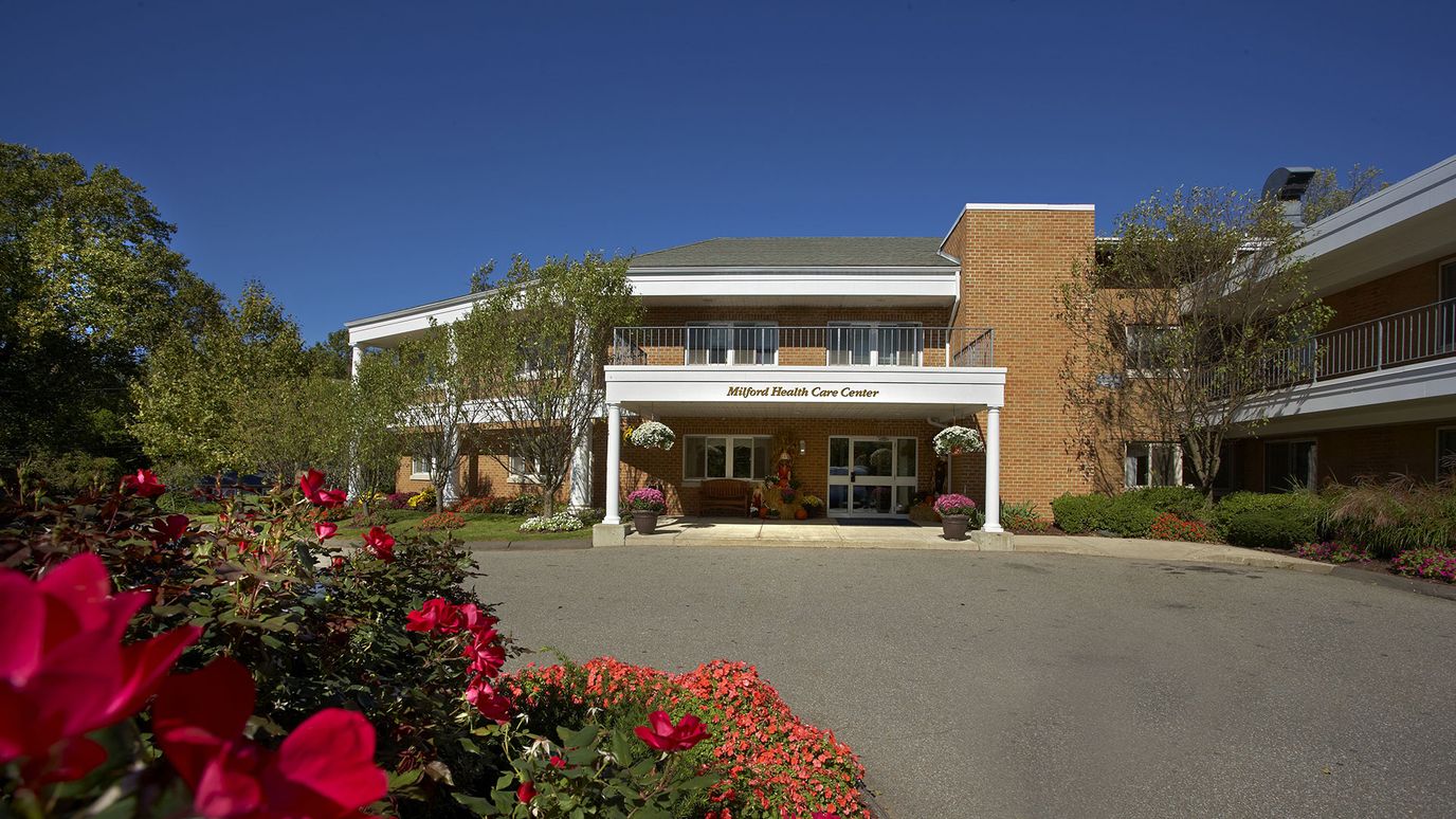 Exterior view of Milford Health Care Center with gardens