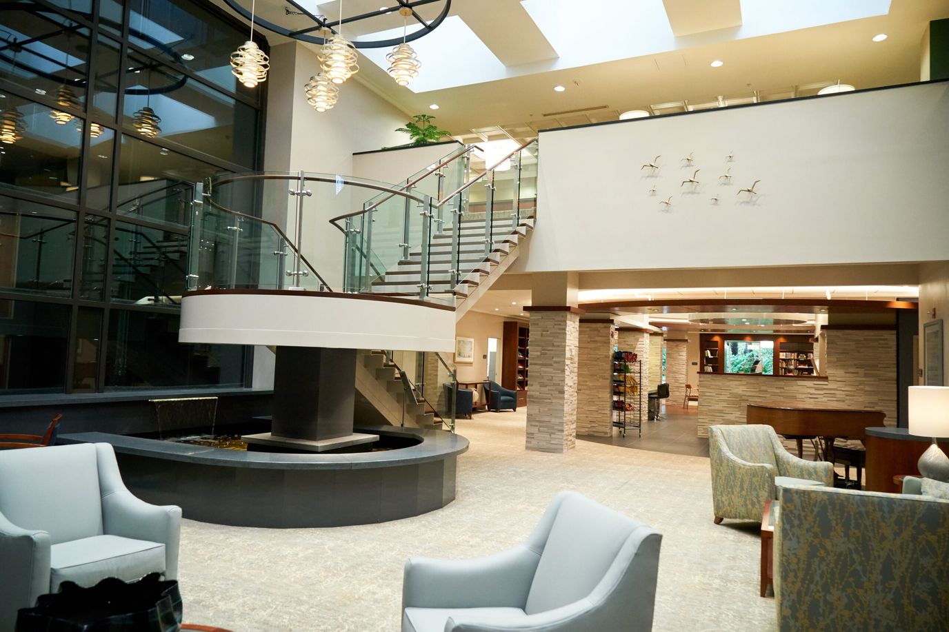 Modern lobby featuring a staircase and seating areas