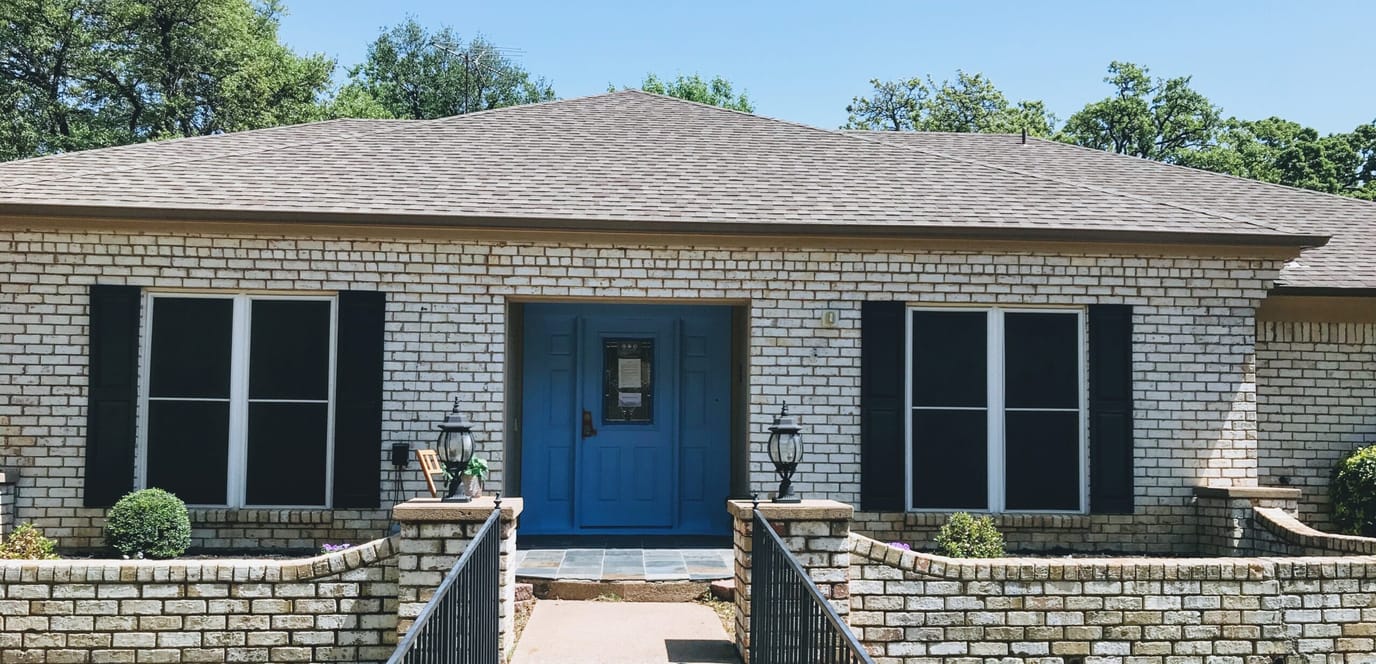 Exterior view of a senior care facility with blue door