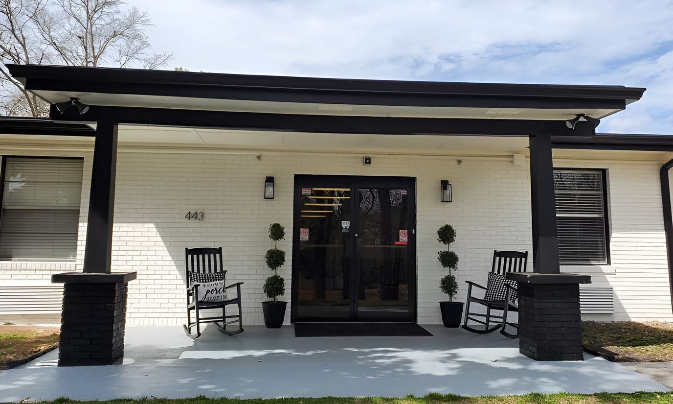 Entrance of The Hudson House with rocking chairs