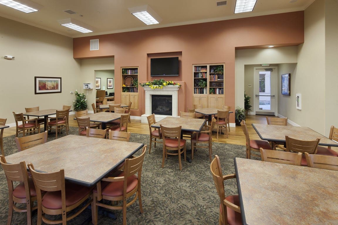 Bright dining area with tables and a fireplace