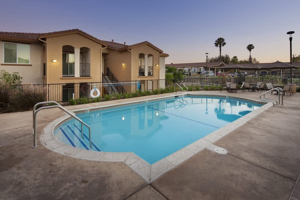 Outdoor swimming pool area with lounge chairs