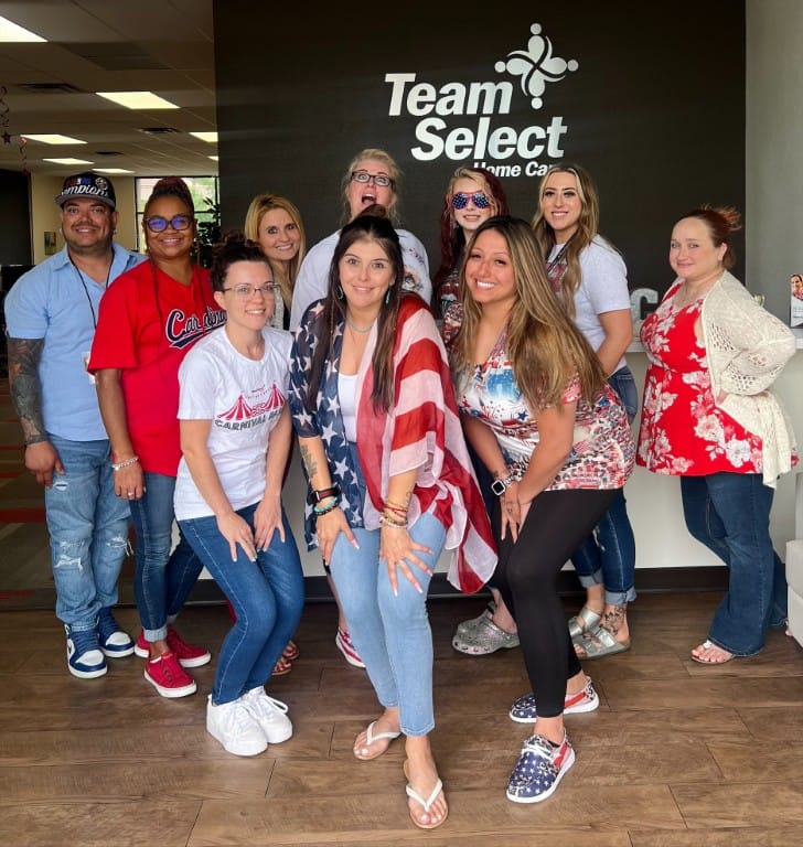 Staff members posing together in a welcoming lobby