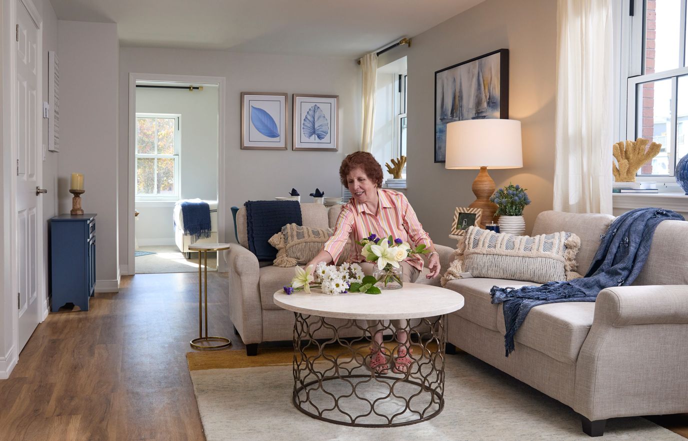 Resident arranging flowers in a cozy living area