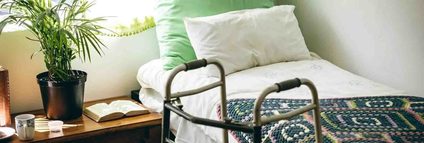 Cozy bedroom with a plant and walker
