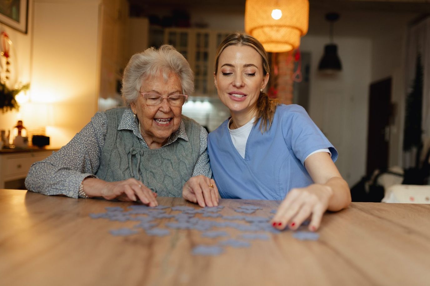 Assisting Hands Home Care Cincinnati, home care in Cincinnati, OH — Two women working on a puzzle at a table