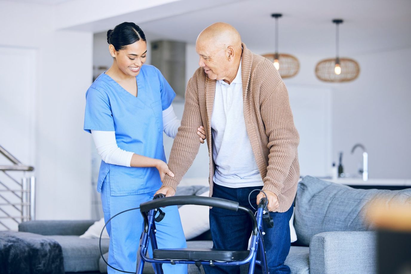 Assisting Hands Home Care Cincinnati, home care in Cincinnati, OH — Caregiver assisting elderly man with walker indoors