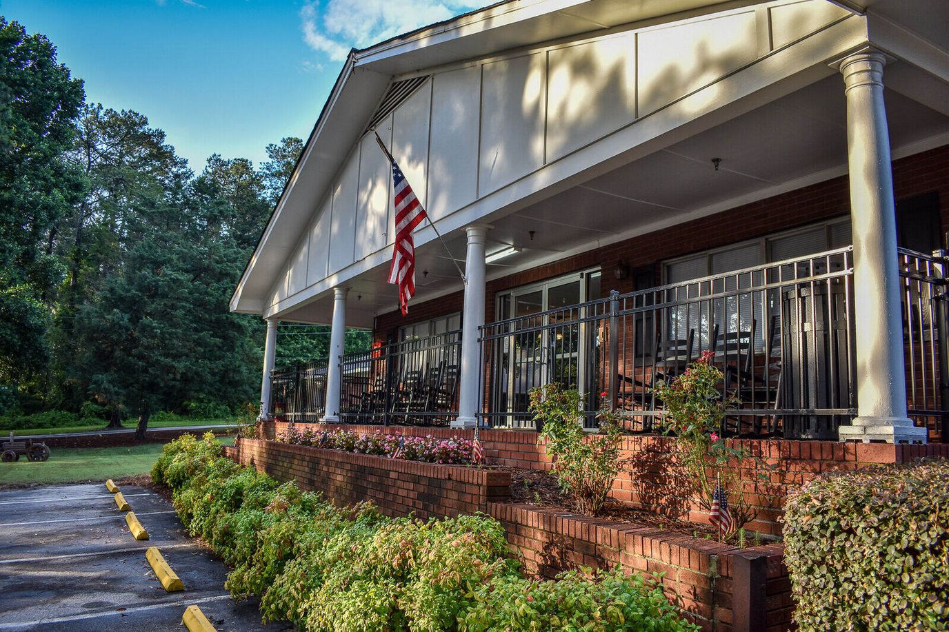 Exterior view of the Winder Center with rocking chairs and flowerbeds