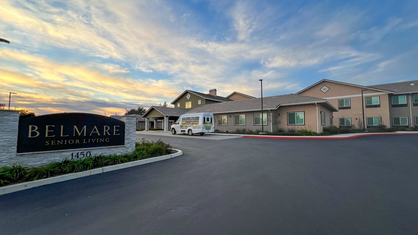 Exterior view of Belmare Senior Living at sunset