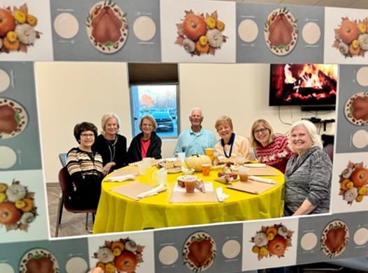 Residents enjoying a festive gathering around a decorated table